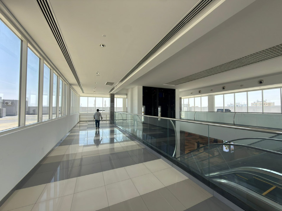 Glass balustrade with stainless steel handrail and aluminium windows in a UAE commercial building