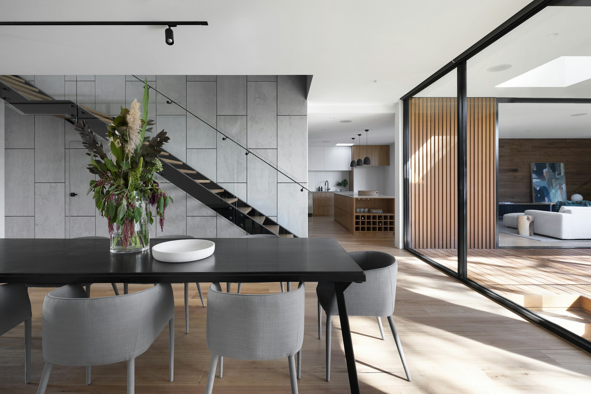 Modern villa interior with black aluminium-framed glass sliding doors (illustrative)