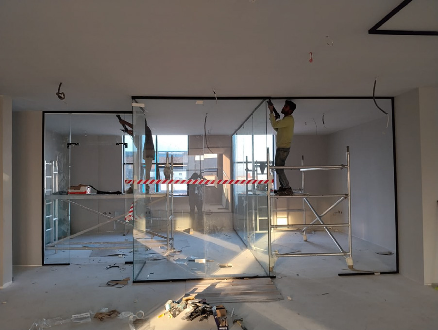 Dreams technician installing a glass partition