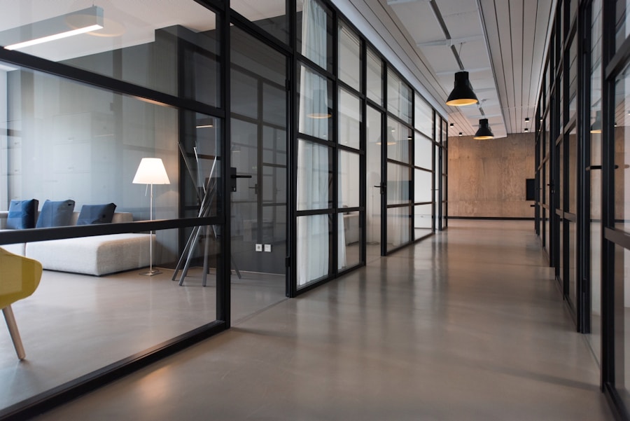 Office corridor with black-framed glass partitions and doors (illustrative)